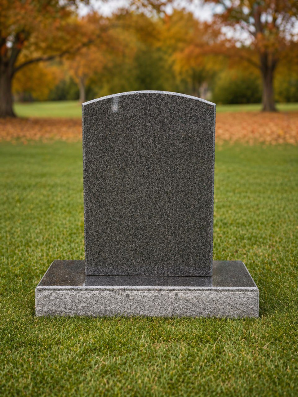Upright granite headstone in cemetery with classic rectangular shape